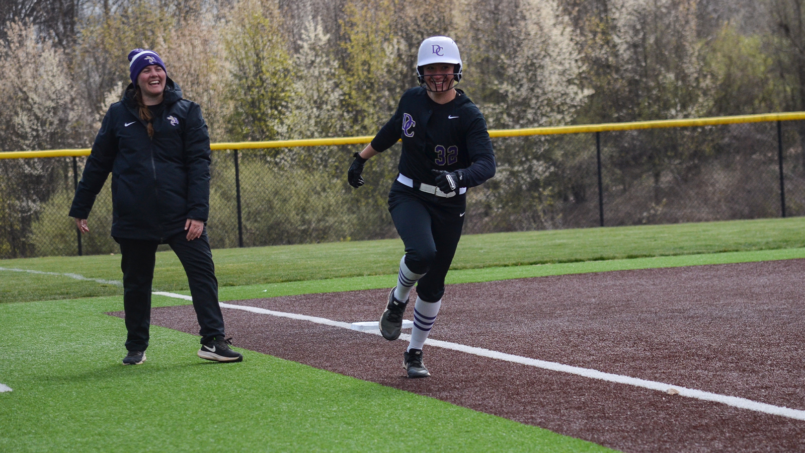 DC softball slugs out first win, splits first day at Pioneer Classic